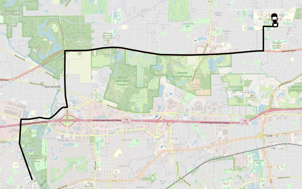A map of DuPage County, Illinois is overlaid with a thick black line depicting a route from Naperville to the College of DuPage. A cartoon car is depicted at the final location, the College of DuPage.