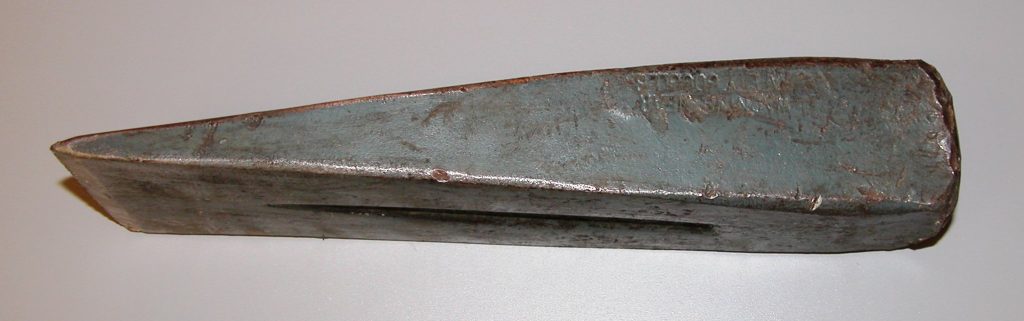 A photograph of a metal wedge.