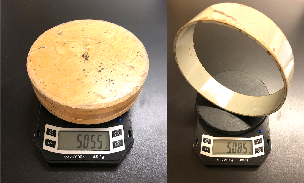 On the left, a solid wooden disk is photographed on a balance with a readout of 505.5 g. On the right, a metallic hoop is photographed on a balance with a readout of 508.5 g.