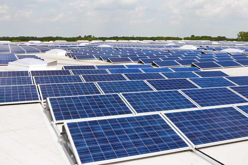 A photograph of multiple solar panels on the rooftop of a building.