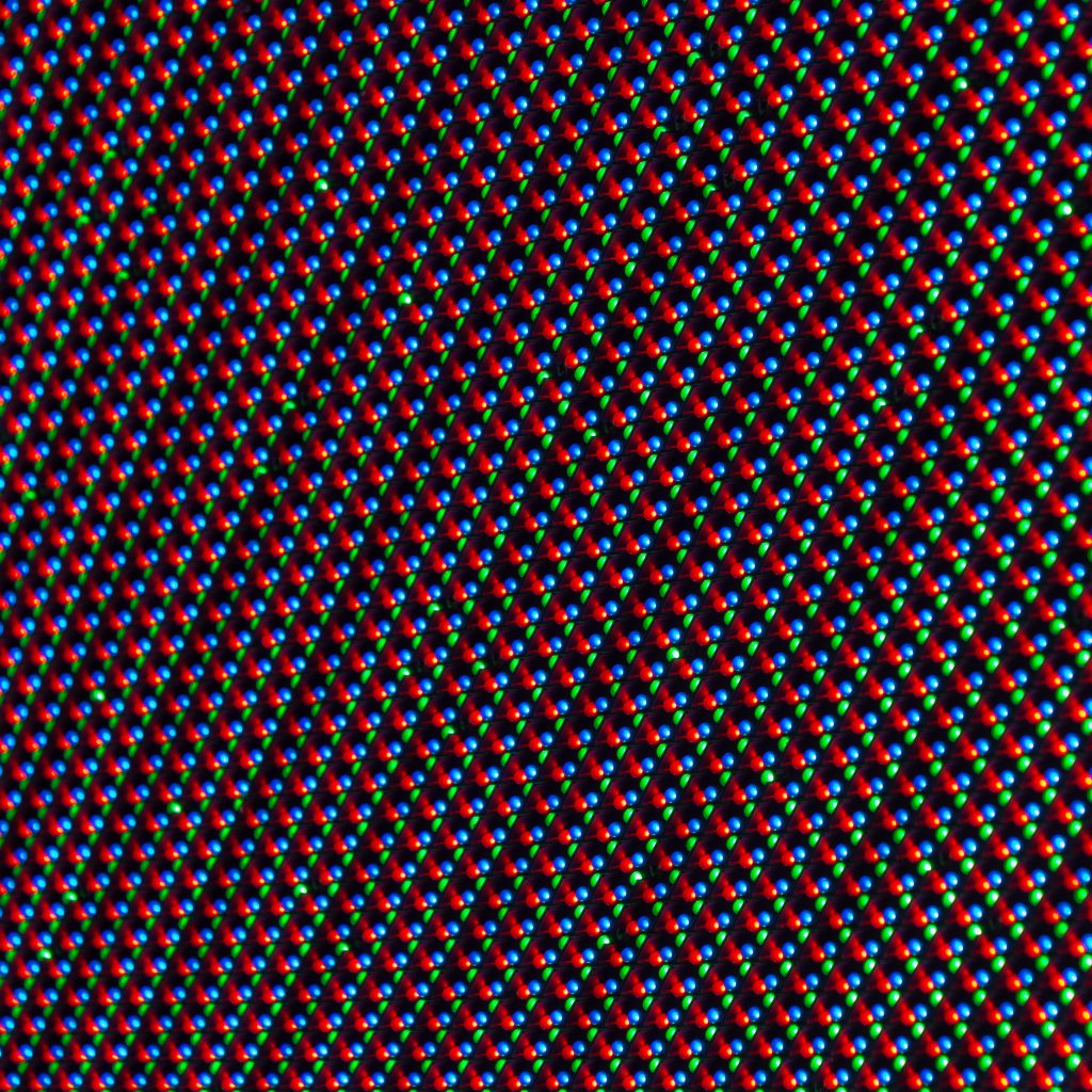 A closeup photograph of an LED display. There are many, closely packed red, green, and blue LEDs visible.