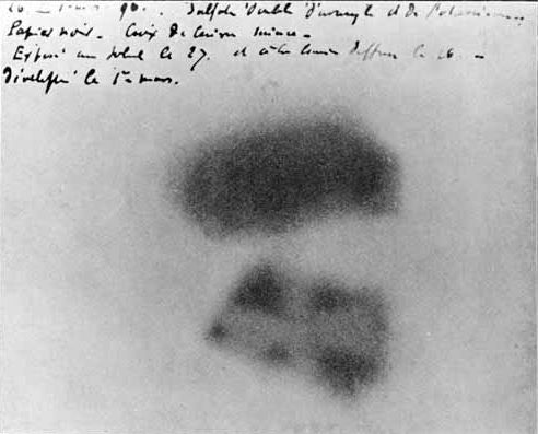 A photograph of the photographic plate of Henri Becquerel. It contains two exposed areas corresponding to the location of the uranium-containing sample. In the upper left is handwriting.