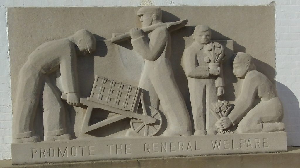 A stone carving reading "Promote the general welfare"