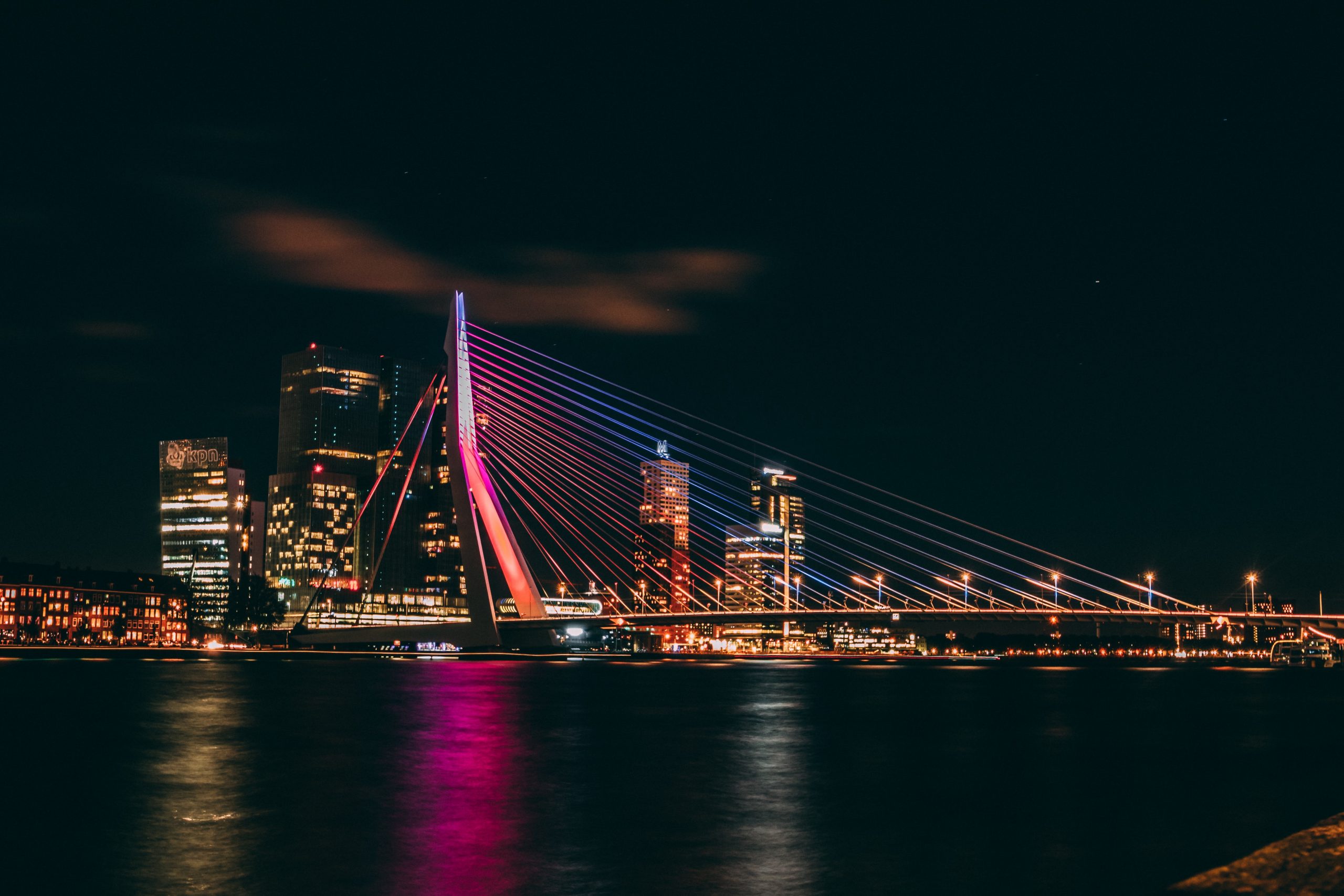 Nighttime photography of the Erasmus Bridge in Rotterdam, Netherlands.