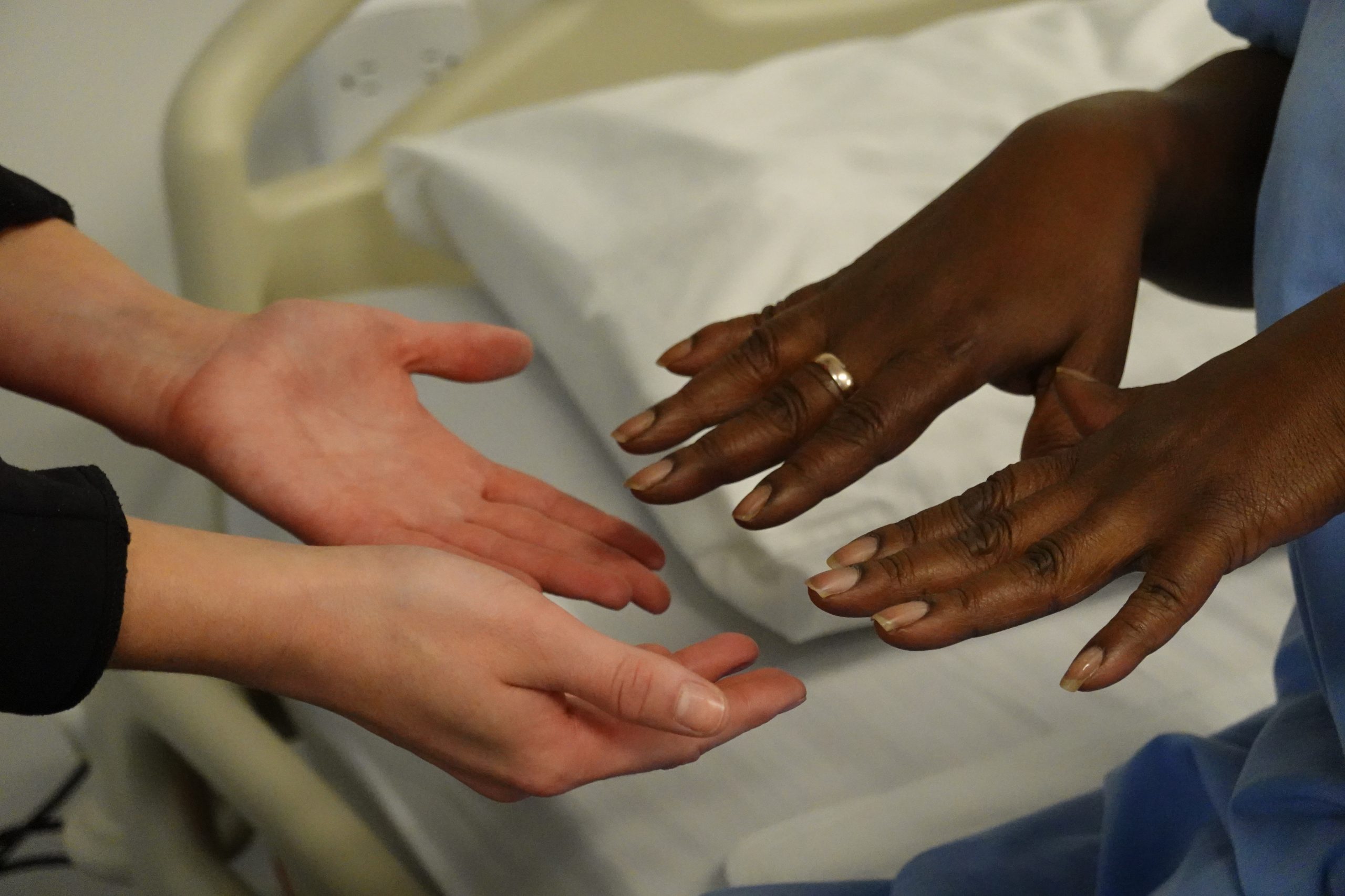 Nurse inspecting client's nail condition.