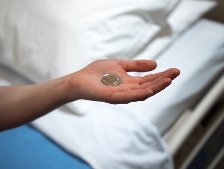 Patient holding a coin in the palm of their hand.