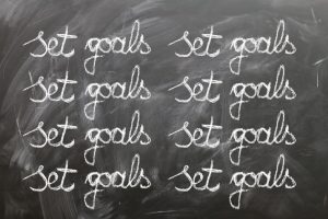 Chalkboard with the phrase "set goals" written repeatedly.