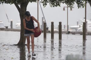 Woman caught in heavy rain in Sydney, Australia.