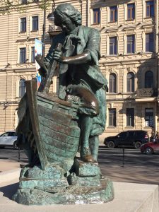 Photograph of a bronze statue of Peter the Great, doing a shipbuilding chore, as seen in St. Petersburg, Russia.