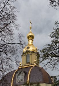 Photograph showing golden dome and cross of Russian Orthodox Church at Peter and Paul Fortress in St. Petersburg, Russia.