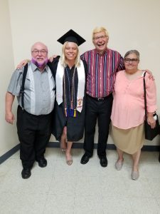 Picture for decorative purposes; Elderly family members with a college graduate celebrating together.
