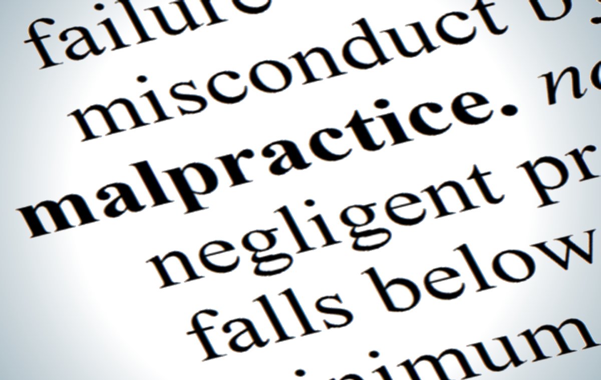image of a closeup of the word malpractice in a dictionary